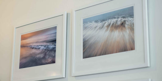 Two paintings of the ocean hung side by side