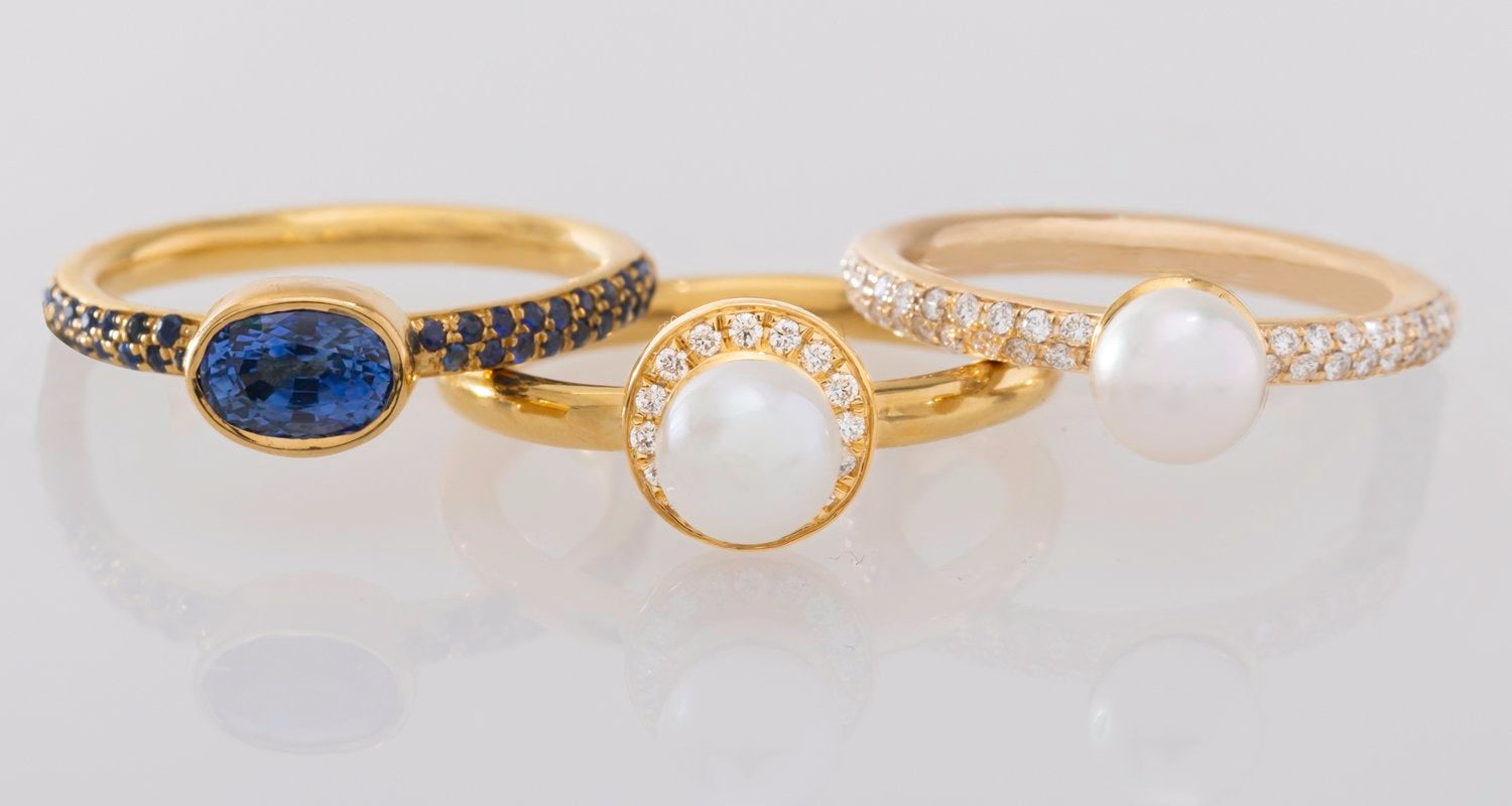 Three rings--one blue, one white, and one encrusted with diamonds
