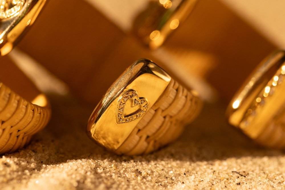 Close up of Summer Love Nantucket Lightship Basket 1" Cuffs with Gold and Diamonds in heart shape sitting in sand