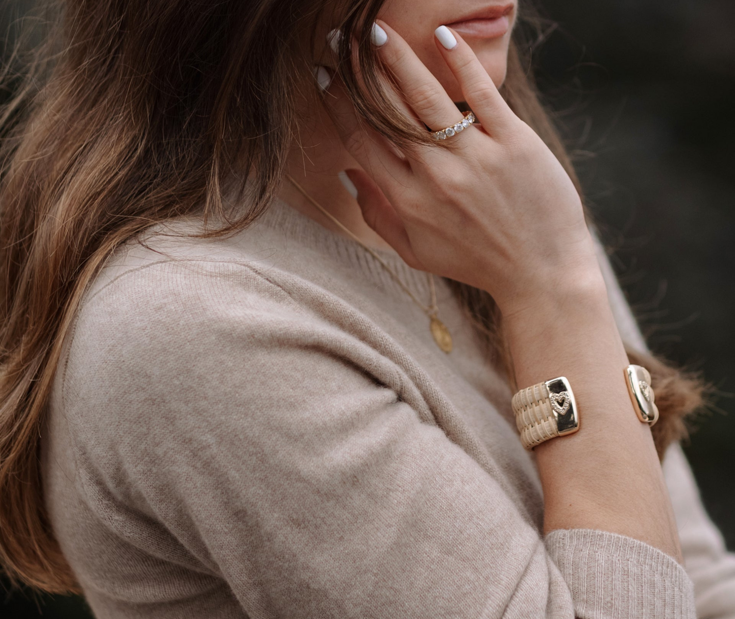 Model wearing Gold Nantucket Cuff with diamond embedded heart embellishment