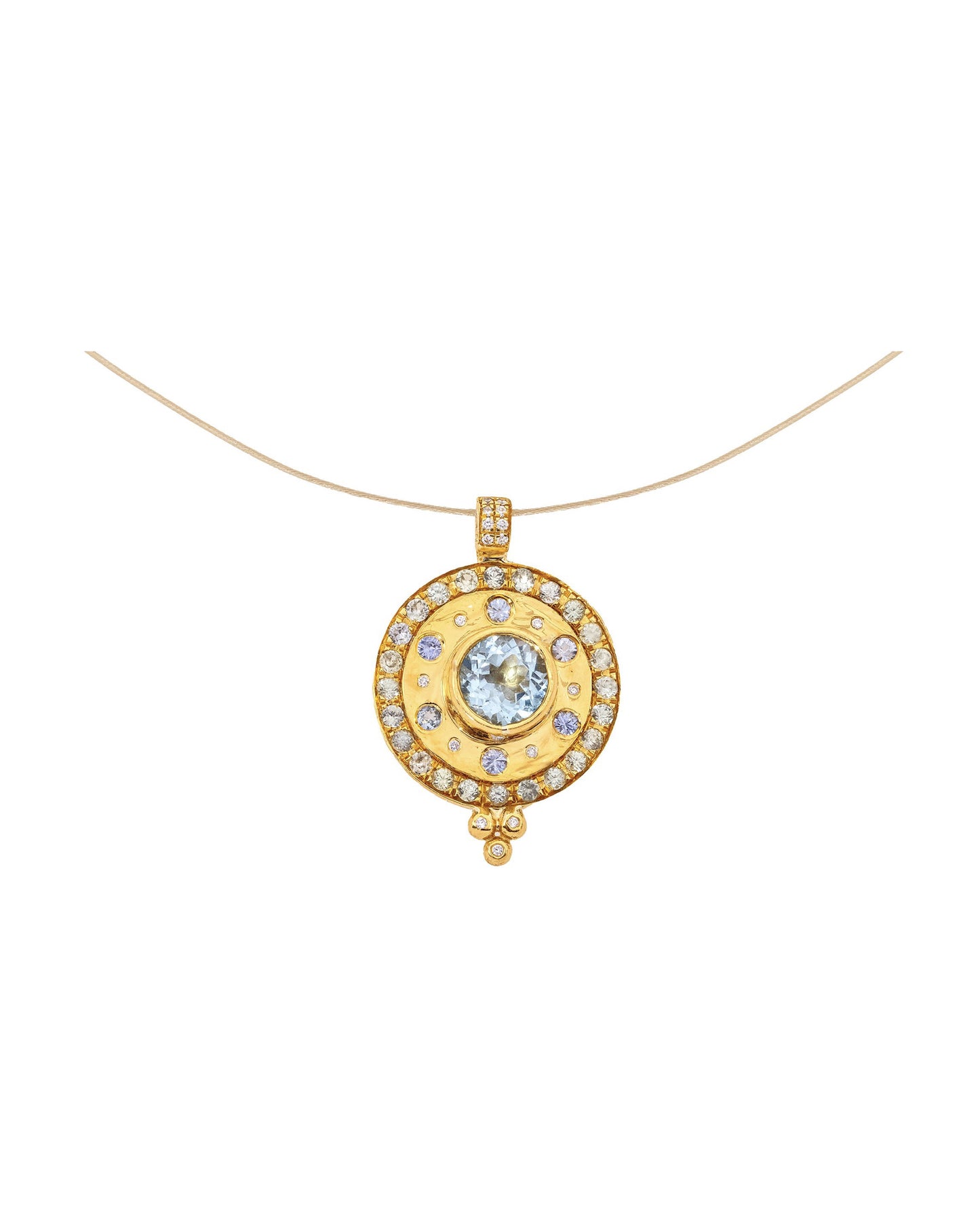 A beautiful mosaic pendant. The Paris & Lily “Dusk” pendant is one-of-a-kind and handcrafted in 22K gold with a 6mm round center aquamarine surrounded by light blue sapphires and diamonds. The pendant has a border of light blue sapphires. Diamonds adorn the chain bail and granules. Shown on a 14K, 16 inch chain.