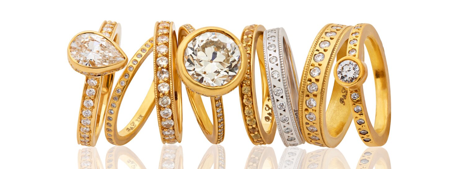assortment of several gold and silver rings encrusted with diamonds