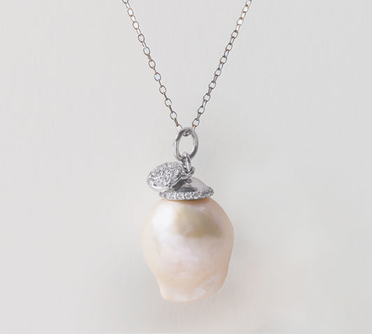 An eloquent, handmade baroque pearl necklace.  Handmade in 14K while gold with sparkling diamond