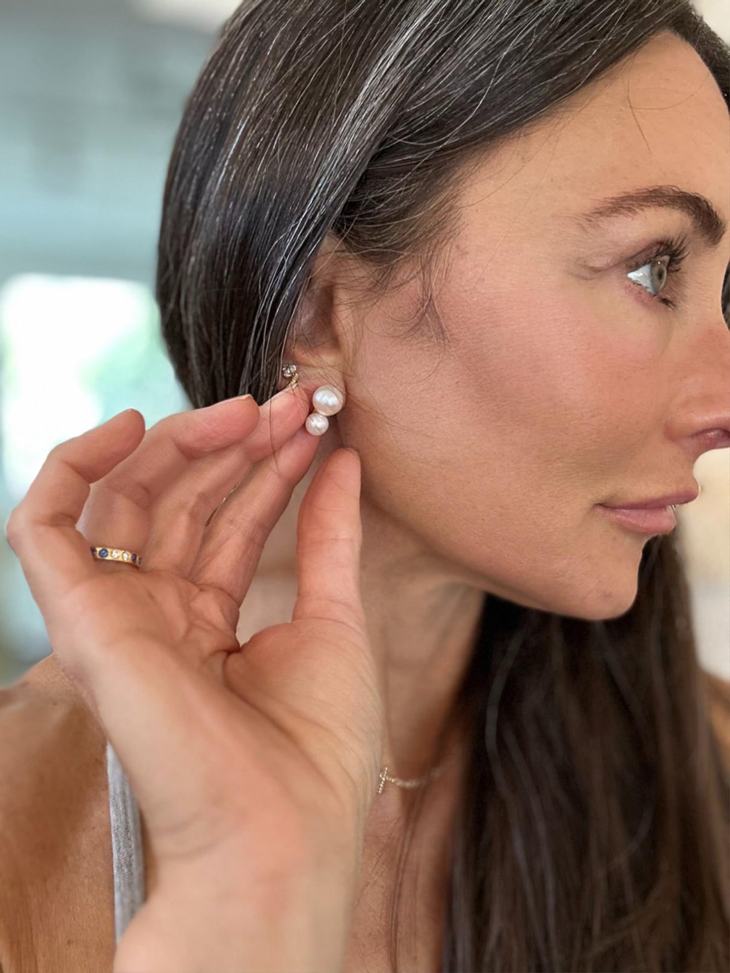 model wearing double pearl gold stud earrings