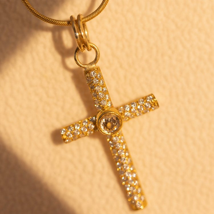 Gold & Diamond Cross Pendant with white backfrop
