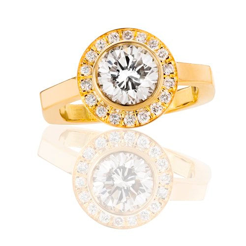 18K gold and diamond halo ring with an emerald shaped band