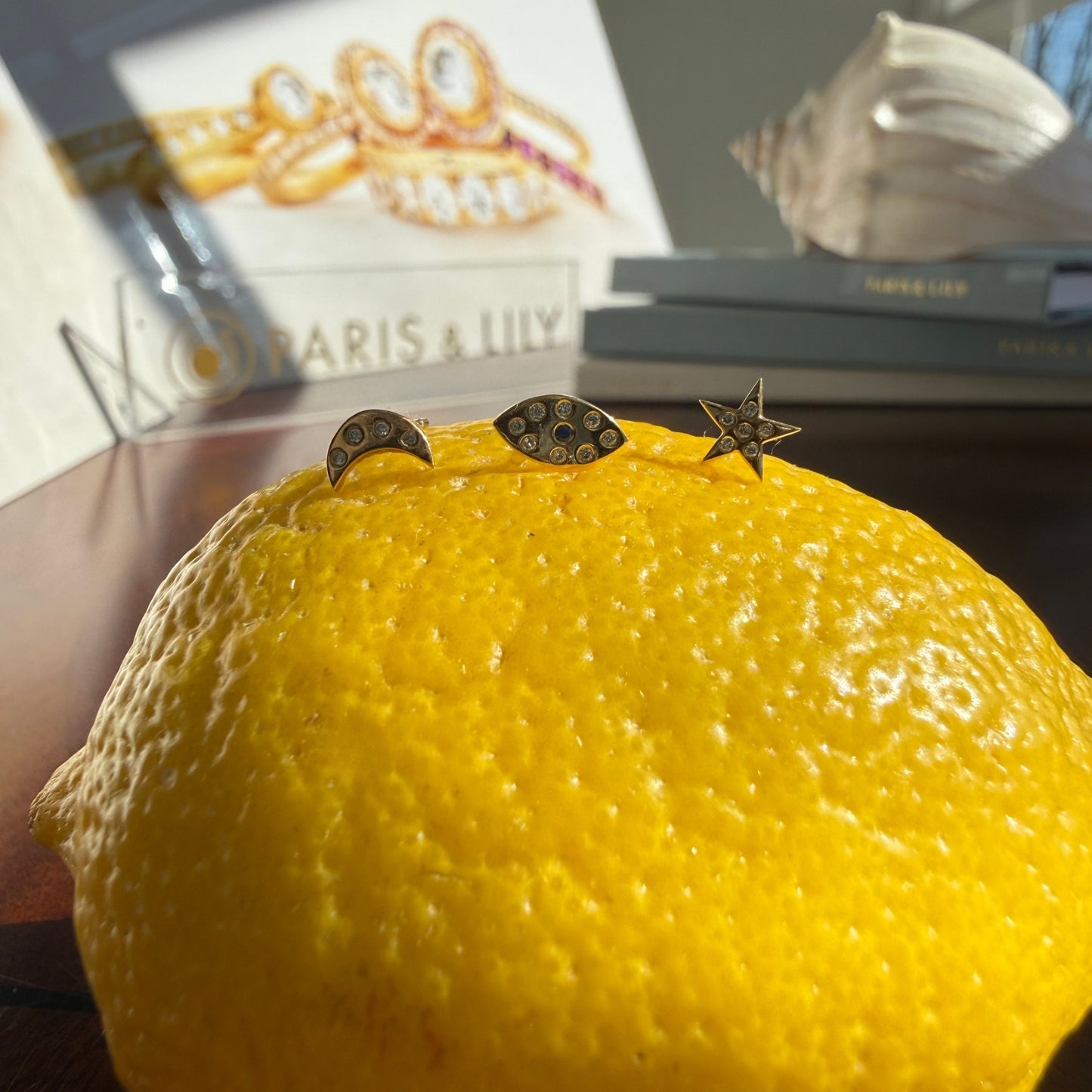 3 Gold studs on lemon for size comparison