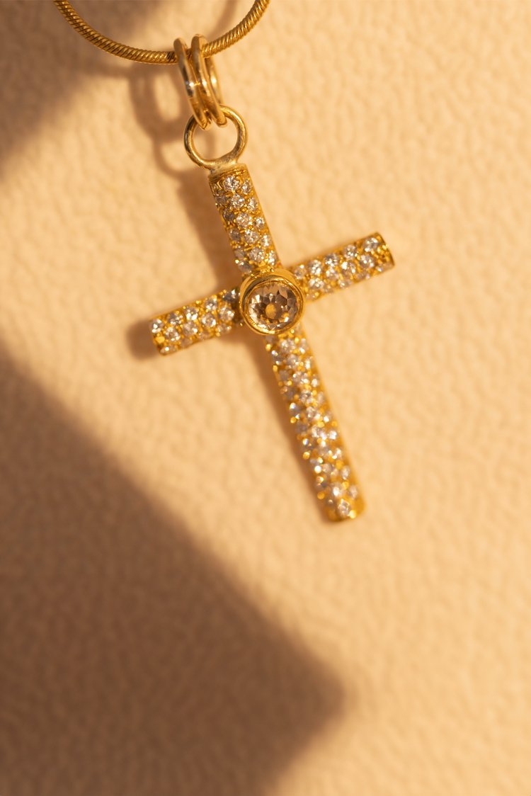 Gold & Diamond Cross Pendant with white backfrop