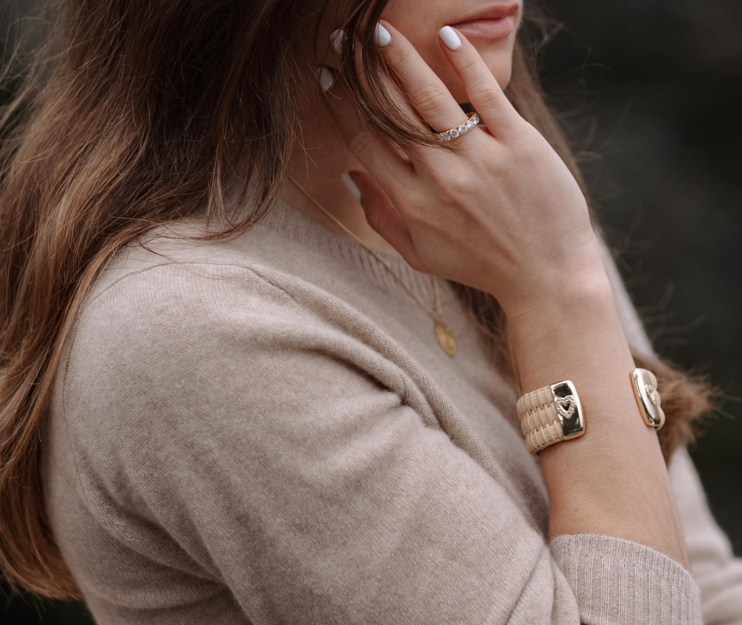 Model wearing Gold Nantucket Cuff with diamond embedded heart embellishment 