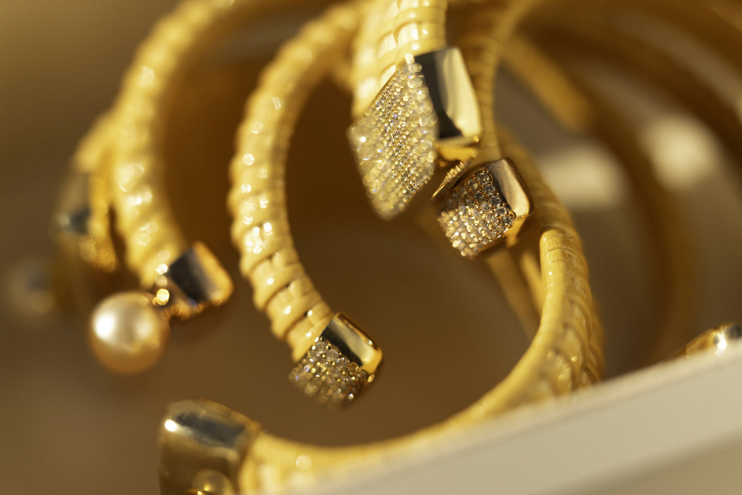 Close-up of details; gold caps with pave diamonds and pearls on Nantucket Basket Cuffs