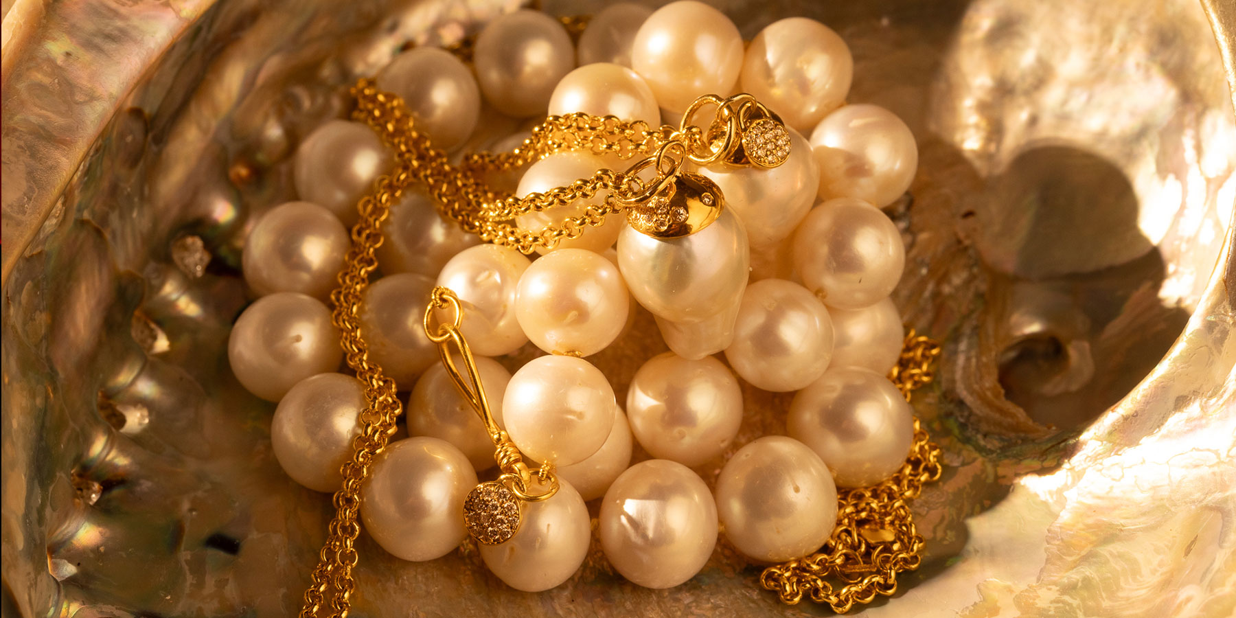 pearls stacked inside of an oyster shell