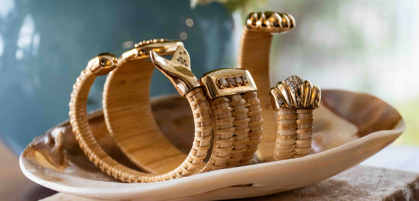 group of nantucket basket cuffs with various gold caps and diamonds in dish