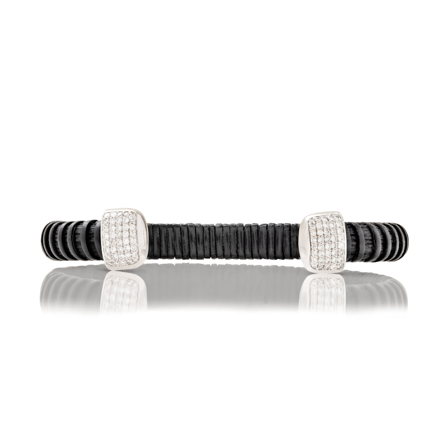 Black woven cuff bracelet with silver caps and diamonds on blank background