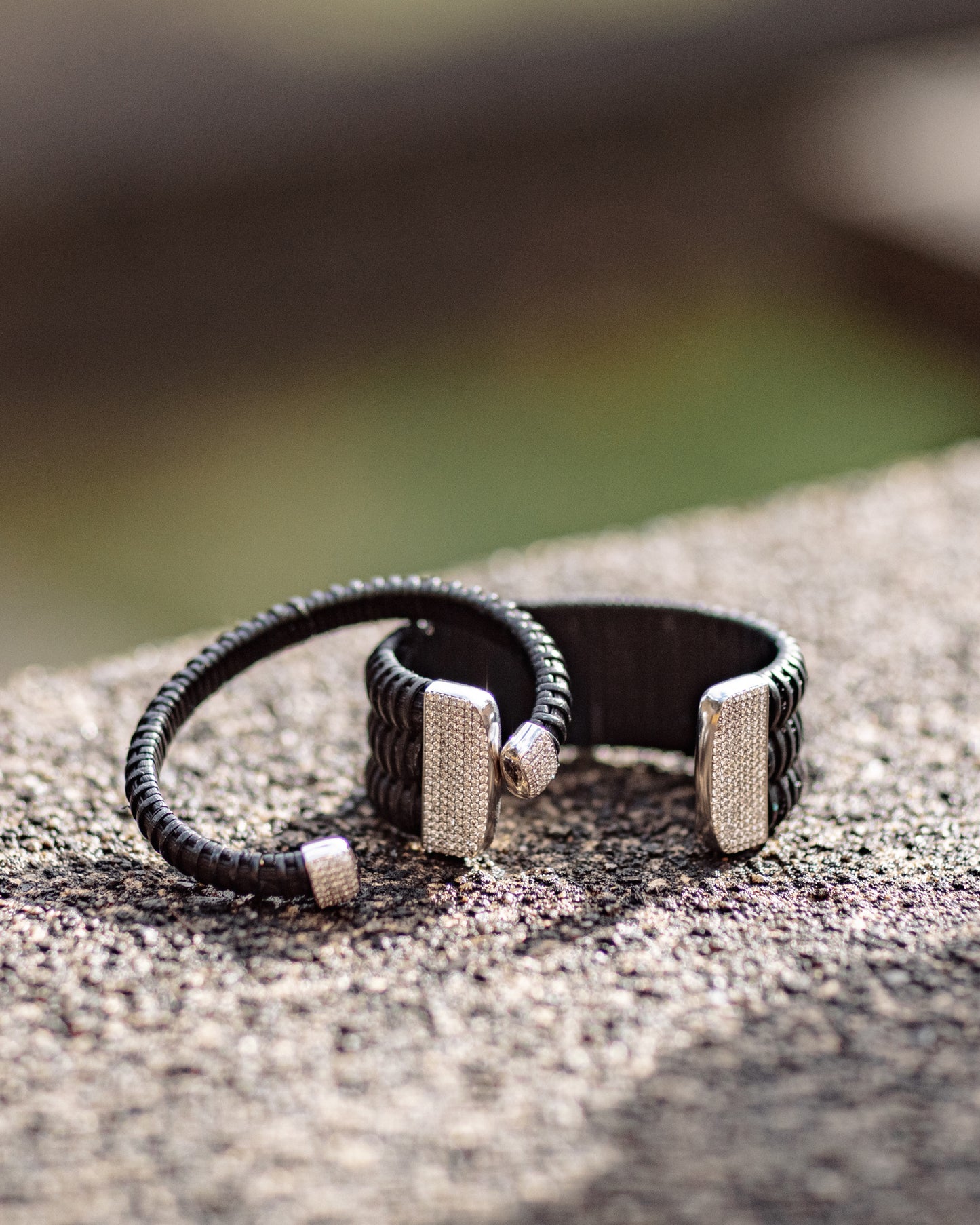 Midnight Swim Nantucket Lightship Basket 1" Cuff with White Gold and Diamonds stacked on stone outside with 1/4" bracelet