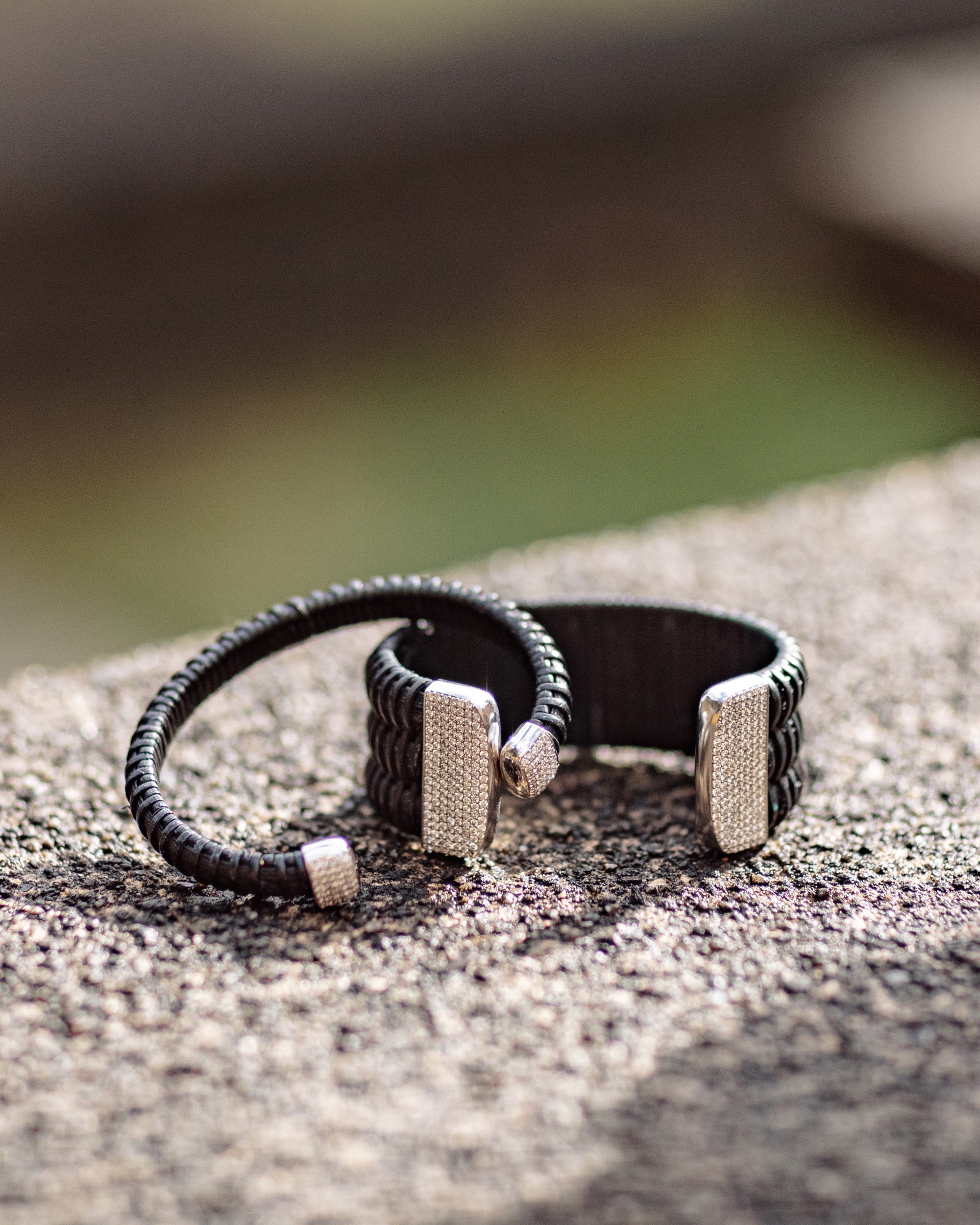 Midnight Swim Nantucket Lightship Basket 1" Cuff with White Gold and Diamonds stacked on stone outside with 1/4" bracelet