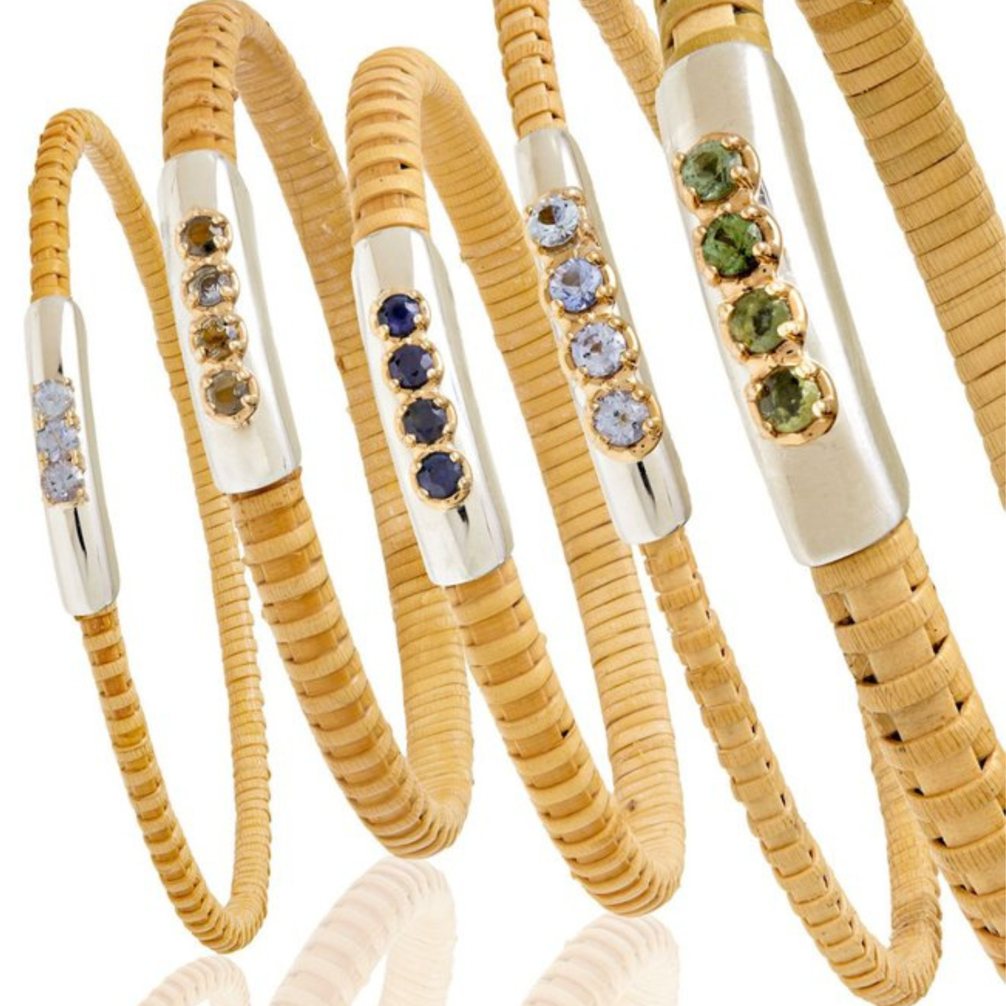 Set of natural rattan woven cuff bracelets with gemstones all standing in a row