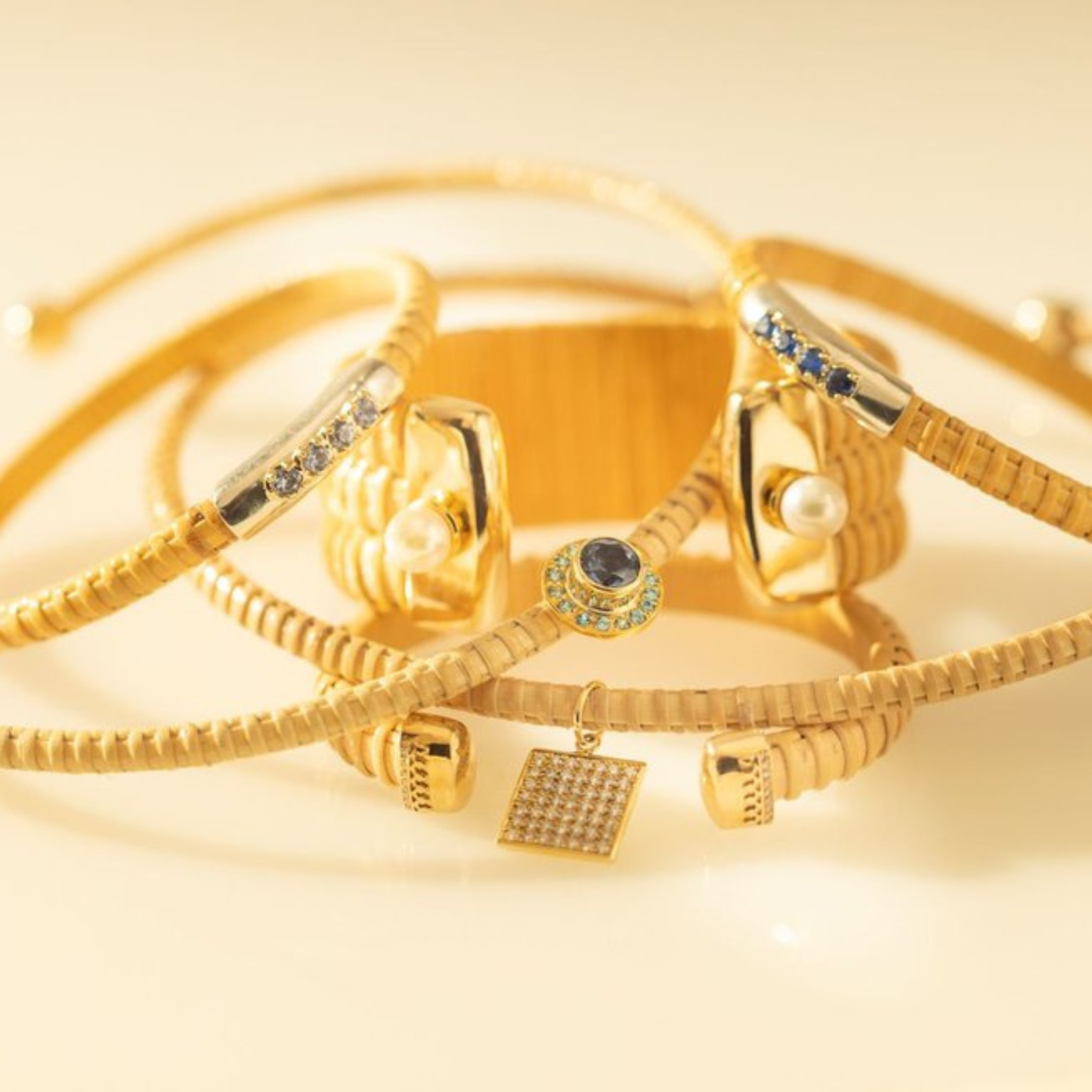 Stack of Natural rattan woven cuff bracelets with various set stones and pearls