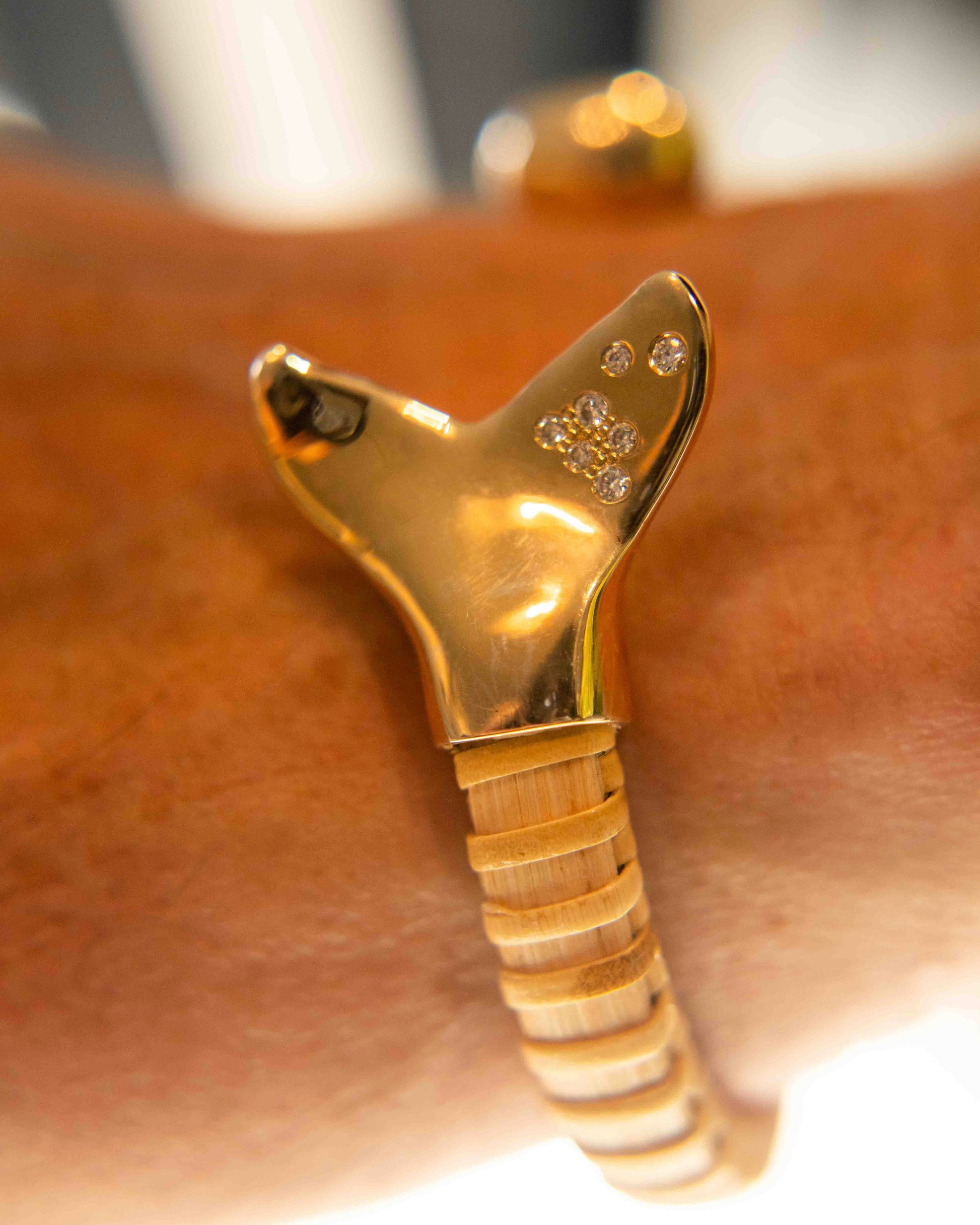 Nantucket Basket bracelet with close up of whale tail shaped gold and diamond cap 