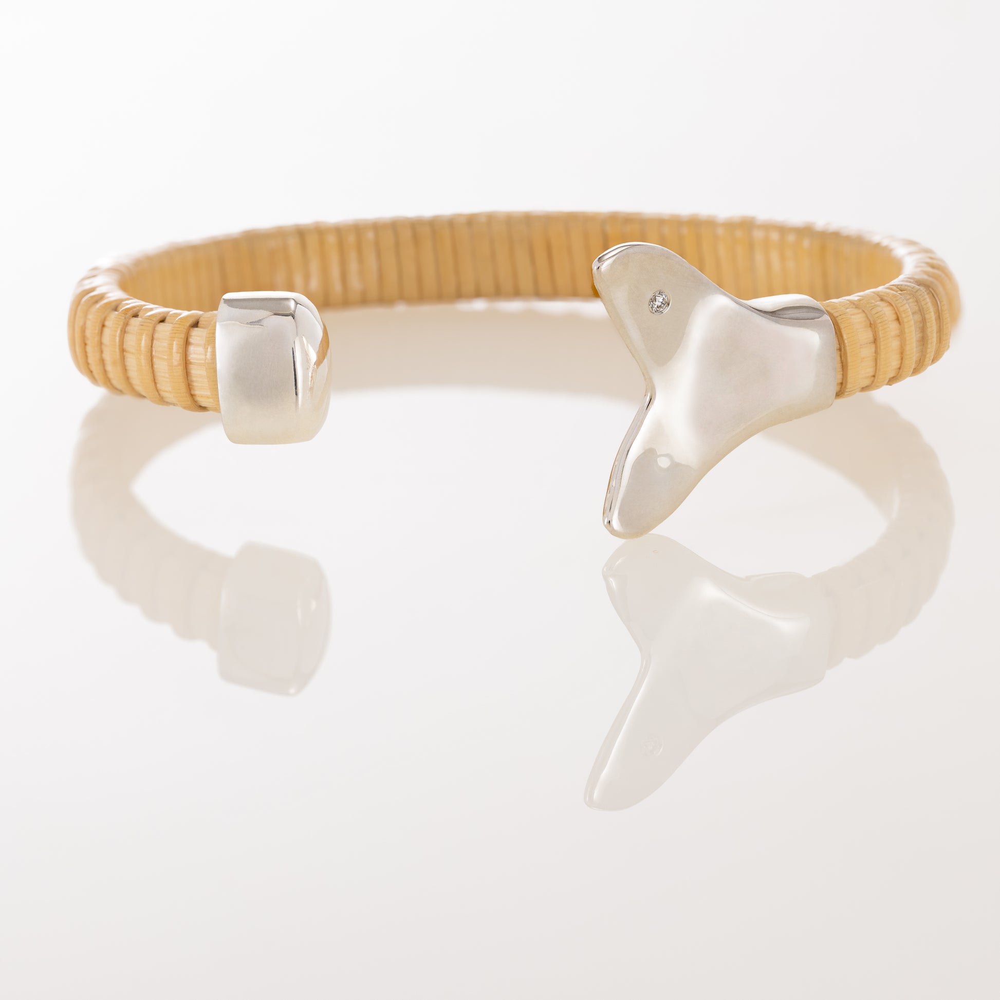 Nantucket Basket Cuff Bracelet with silver whale tail caps and diamond accents on plain background