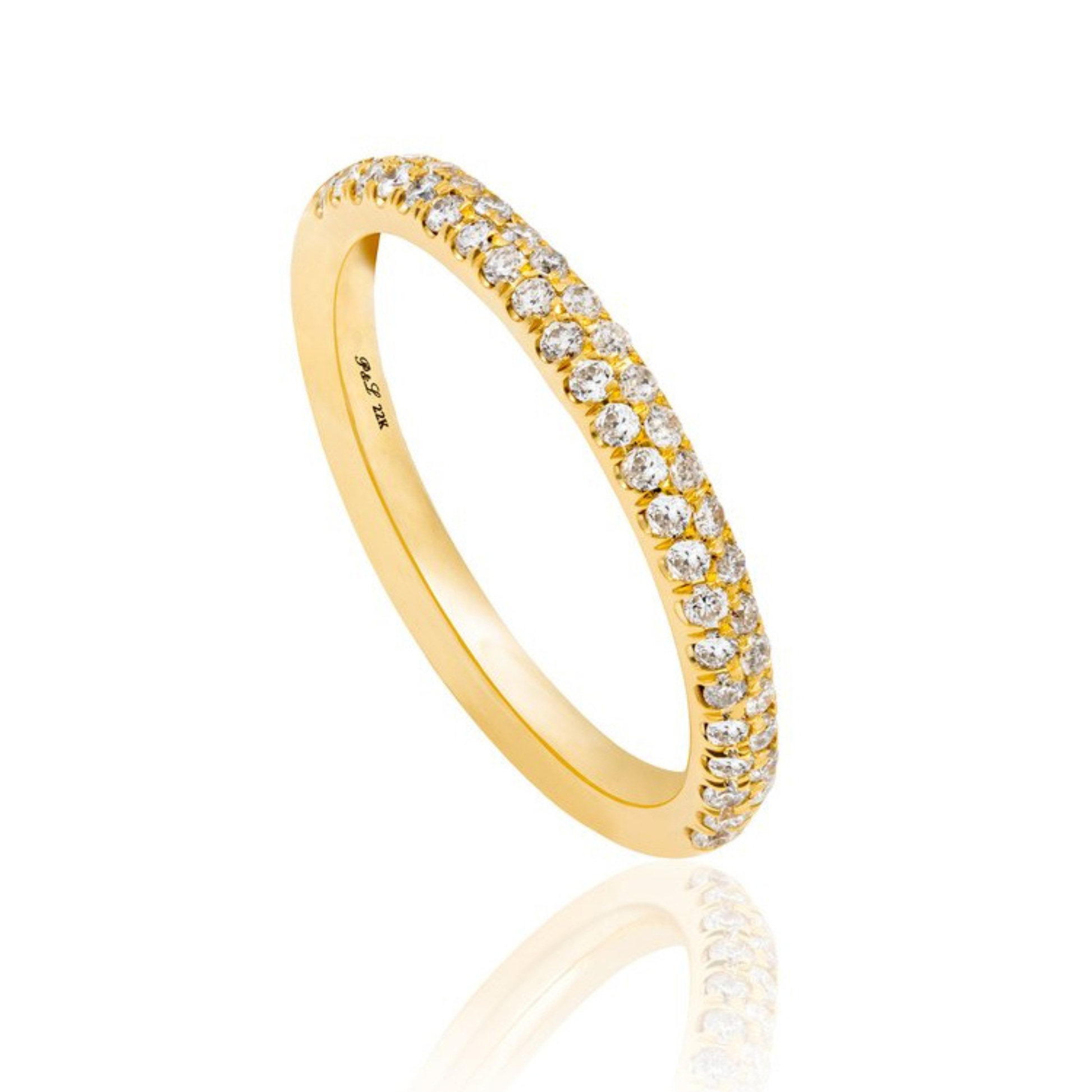 A yellow gold eternity ring set with round brilliant-cut diamonds, shown on a clean white background with a soft reflection below.