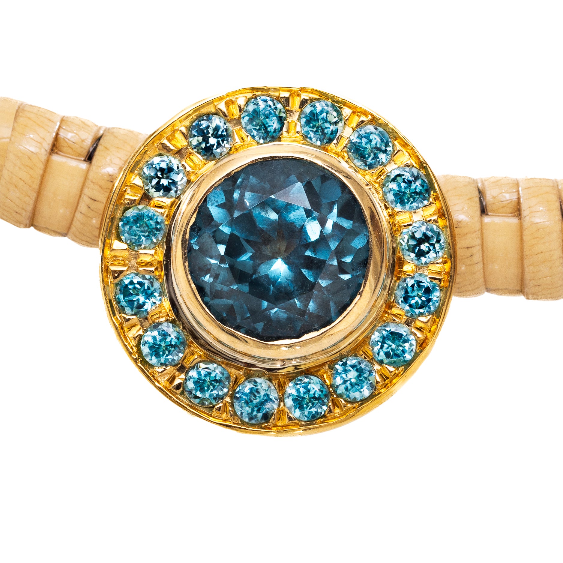 close up of gem on nantucket basket necklace, in blue and gold