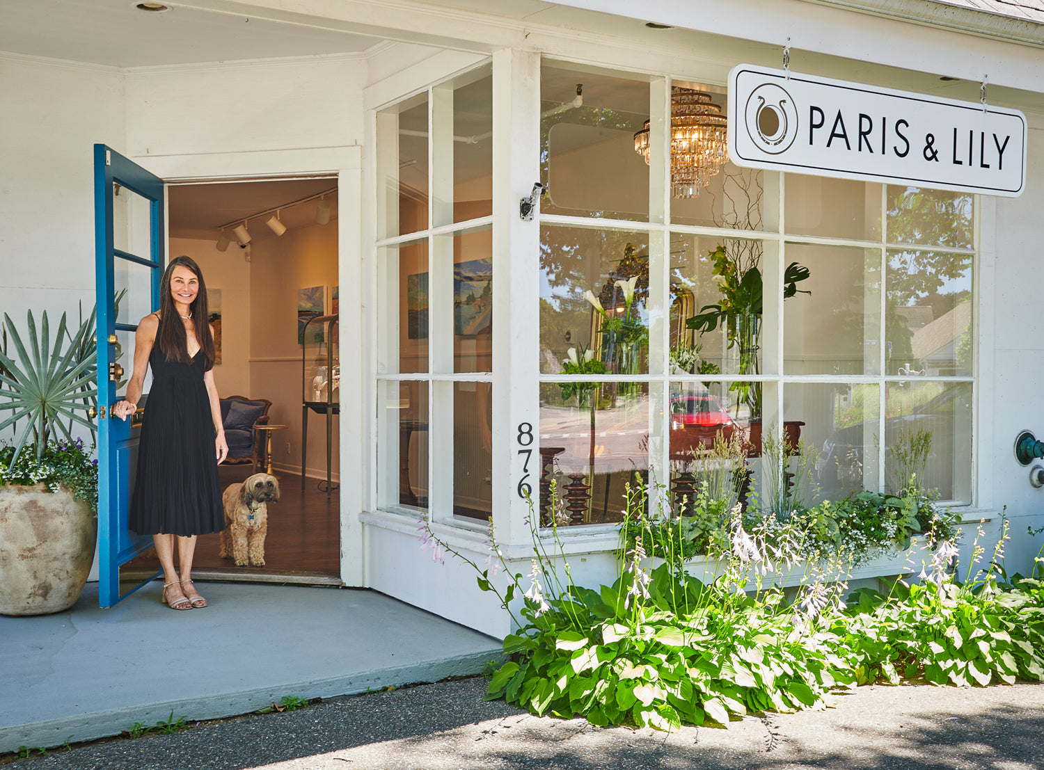 Photo of Jen and her dog opening the door to her flagship store